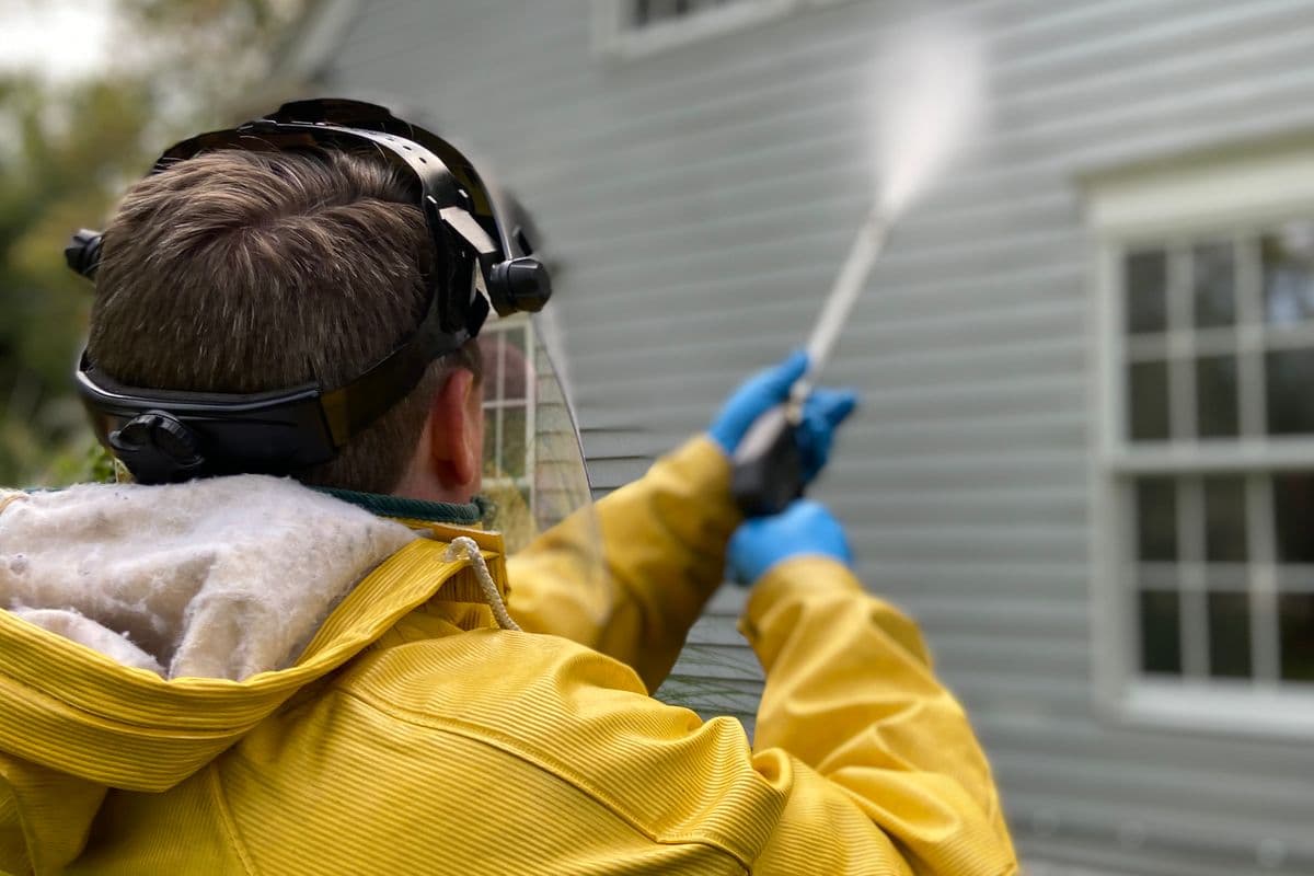 Professional pressure washing a house exterior in Greenville, SC